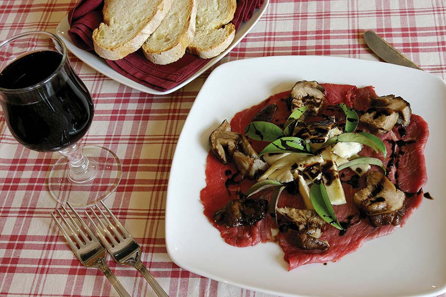 Beef Carpaccio with a Warm Mushroom Salad, Rocket and Parmesan
